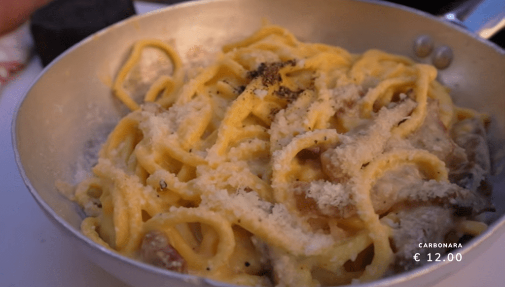 Carbonara is made with eggs, cheese, bacon, and black pepper